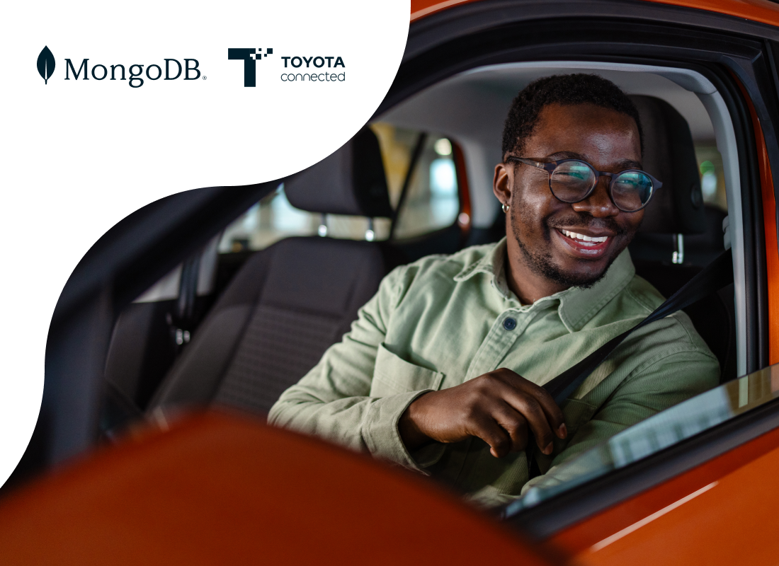 Person smiling and wearing a seat belt inside a car.